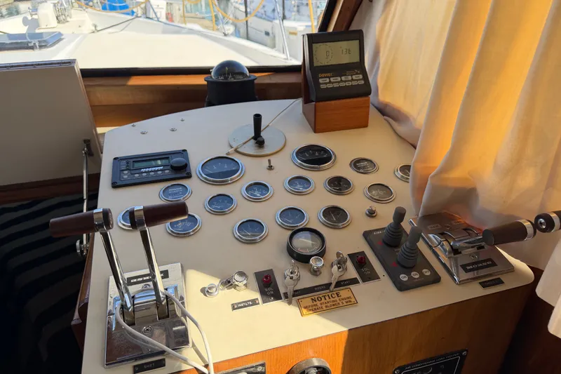 Slide: The Image of Cockpit controls of a 1984 Californian 43 Cockpit MY yacht, featuring gauges and levers. - 26