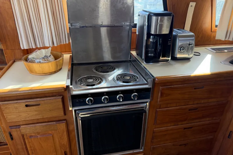 Slide: The Image of 1984 Californian 43 Cockpit MY kitchen with stove, coffee maker, and toaster. - 21