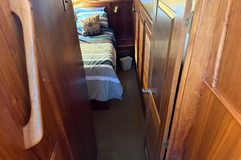 Slide: The Image of 1984 Californian 43 Cockpit MY interior with wooden paneling and cozy bedroom. - 40