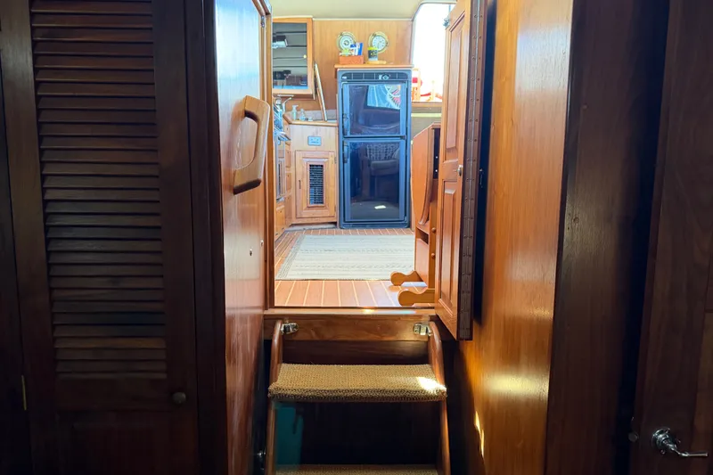 Slide: The Image of Interior view of 1984 Californian 43 Cockpit MY yacht with wooden cabinetry and stairs. - 38