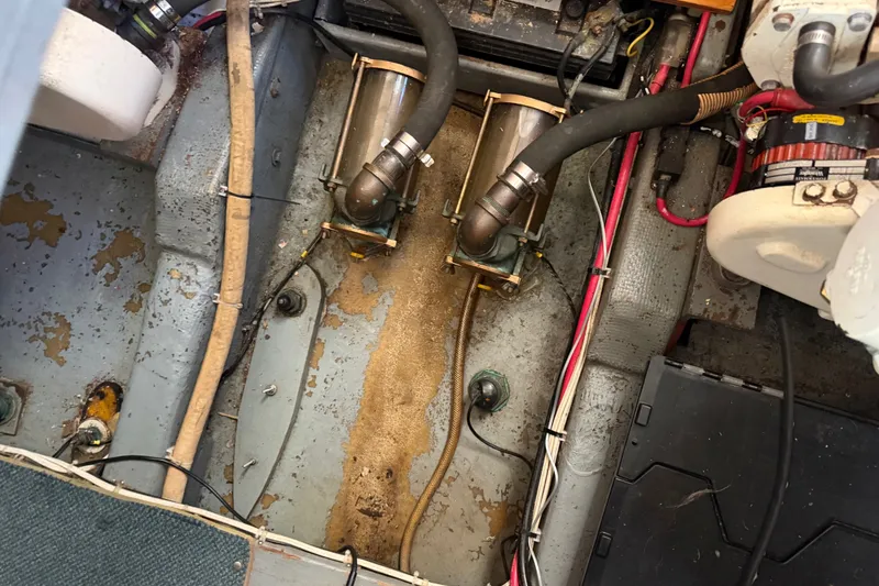 Slide: The Image of Engine compartment of a 1984 Californian 43 Cockpit MY boat, showing hoses and wiring. - 56