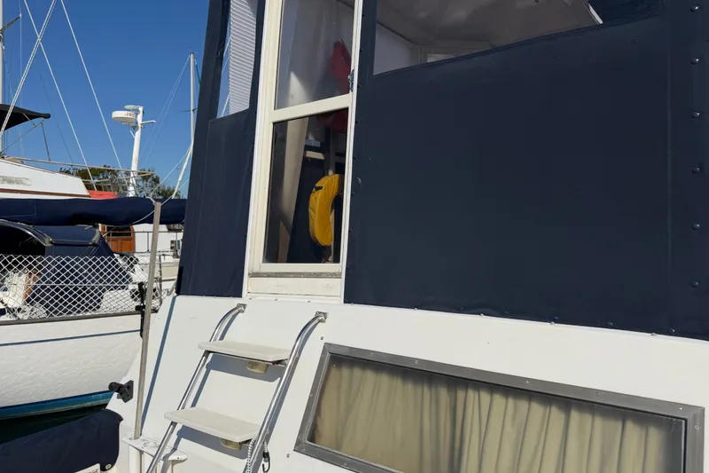Slide: The Image of 1984 Californian 43 Cockpit MY yacht with steps and window, docked at marina. - 63