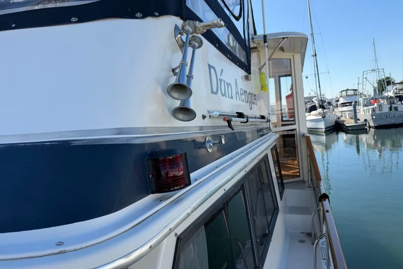 Slide: The Image of 1984 Californian 43 Cockpit MY boat docked in marina, side view with name visible. - 60