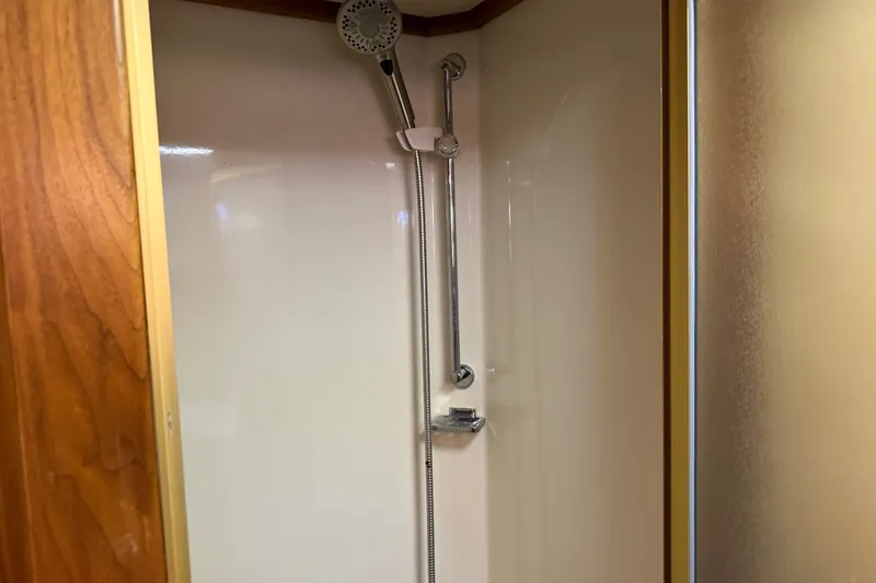 Slide: The Image of Shower area inside 1984 Californian 43 Cockpit MY yacht, featuring wood accents and modern fixtures. - 50