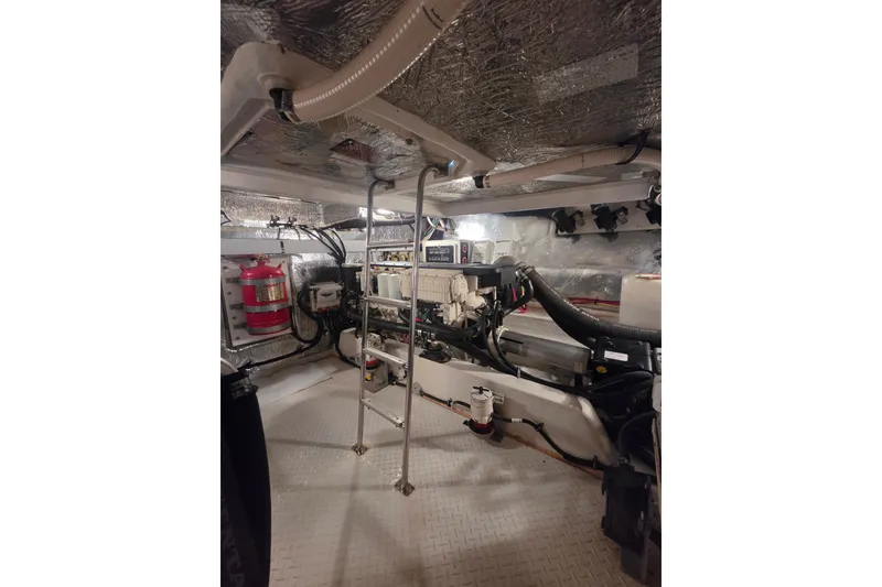 Slide: The Image of Engine room of 2014 Cruisers Yachts 45 Cantius with visible machinery and fire extinguisher. - 41