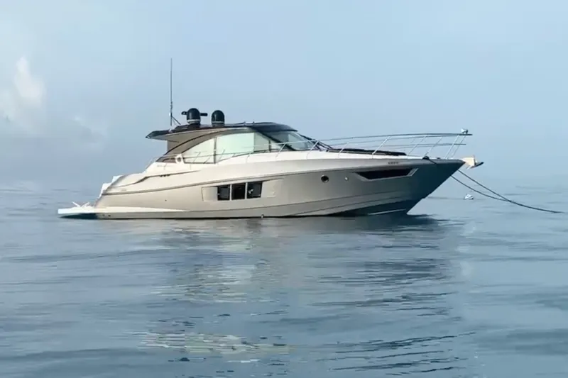 The Image of 2014 Cruisers Yachts 45 Cantius on calm water, showcasing sleek design and luxury features. - 0