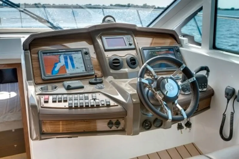 Slide: The Image of Manufacturer Provided Image: 2014 Cruisers Yachts 45 Cantius helm with navigation screens and steering wheel. - 10