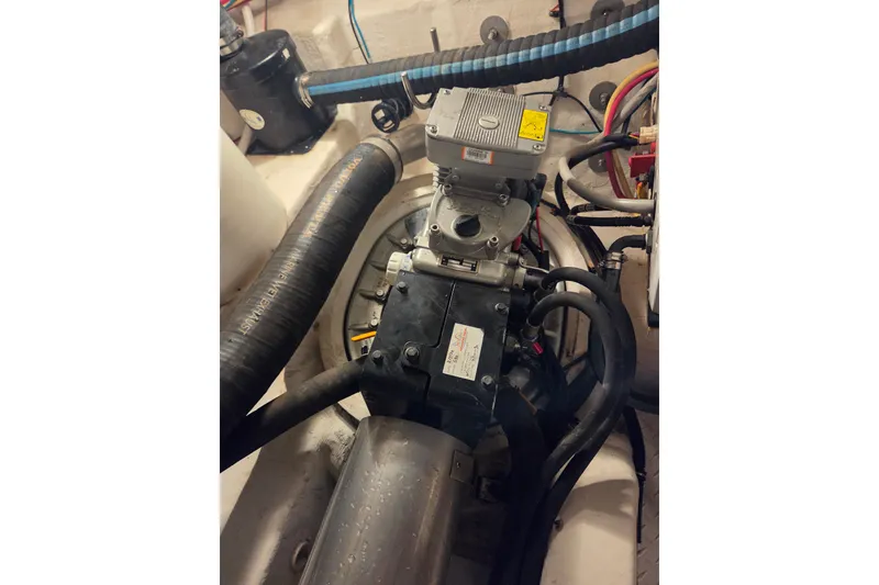 Slide: The Image of Engine compartment of 2014 Cruisers Yachts 45 Cantius with visible hoses and components. - 44