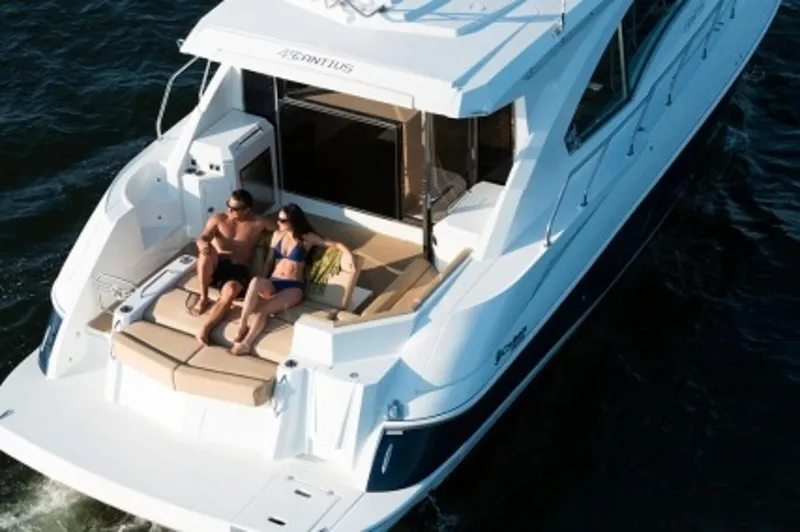 Slide: The Image of Manufacturer Provided Image: 2014 Cruisers Yachts 45 Cantius on water, couple relaxing on deck. - 5
