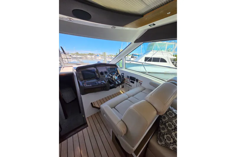 Slide: The Image of Interior view of 2014 Cruisers Yachts 45 Cantius helm with modern controls and seating. - 23