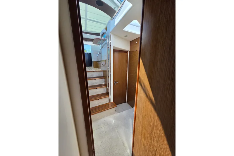 Slide: The Image of Interior view of 2014 Cruisers Yachts 45 Cantius, featuring wooden stairs and modern design. - 20