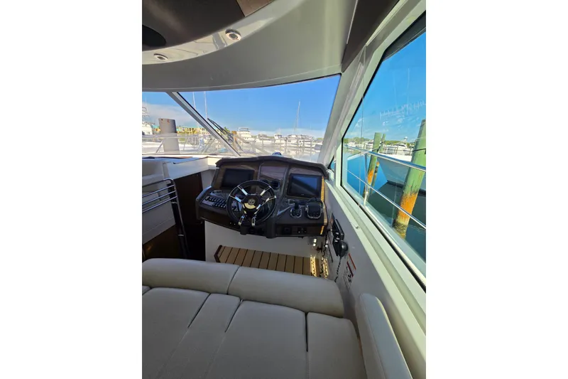 Slide: The Image of Interior helm of 2014 Cruisers Yachts 45 Cantius with modern controls and panoramic view. - 24