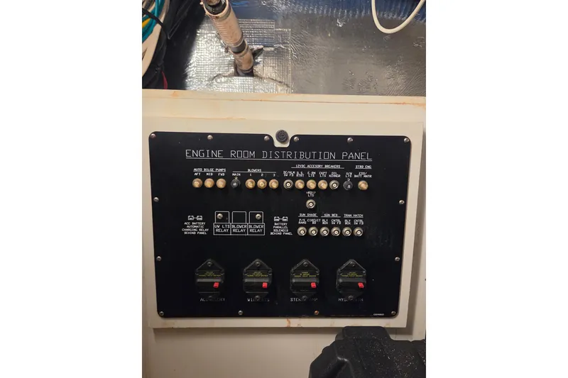 Slide: The Image of Engine room distribution panel on 2014 Cruisers Yachts 45 Cantius, showcasing controls and switches. - 37