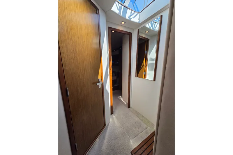 Slide: The Image of Interior hallway of 2014 Cruisers Yachts 45 Cantius with wooden doors and skylight. - 19