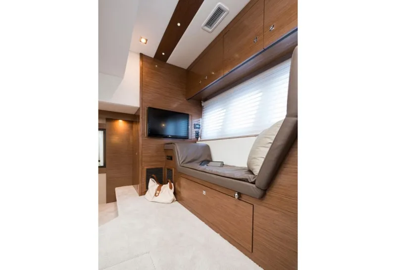 Slide: The Image of Manufacturer Provided Image: Interior of 2014 Cruisers Yachts 45 Cantius with seating, TV, and wooden cabinetry. - 17