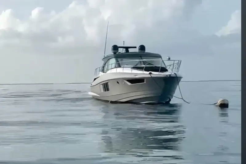 Slide: The Image of 2014 Cruisers Yachts 45 Cantius on calm water under cloudy sky. - 1
