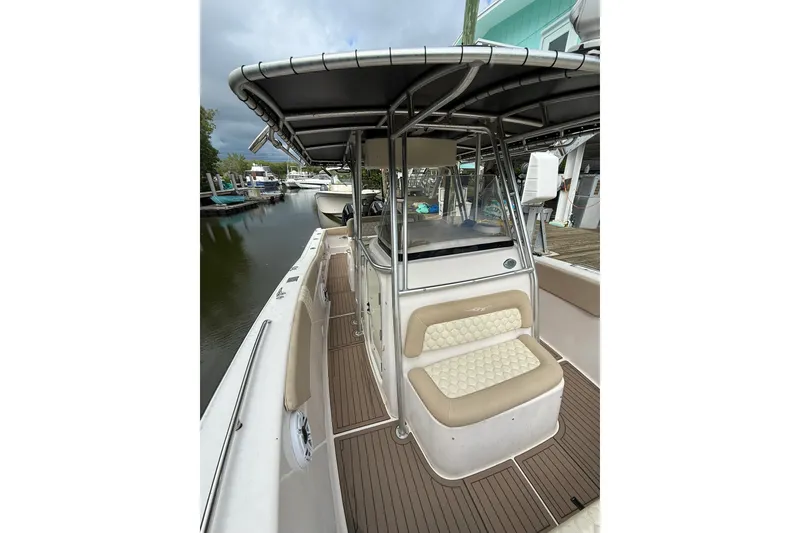 Slide: The Image of 2004 Grady-White Canyon 306 boat with seating and canopy, docked by the water. - 36