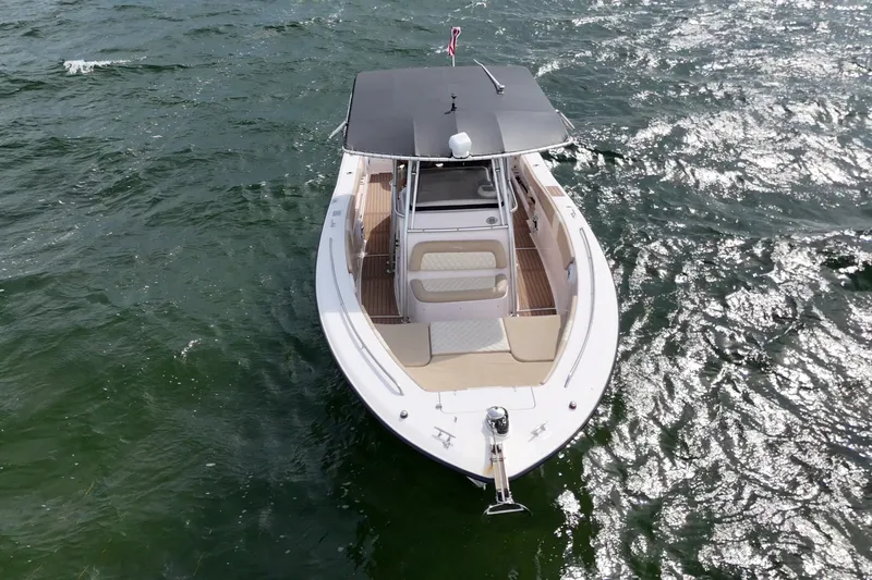 Slide: The Image of 2004 Grady-White Canyon 306 boat on shimmering water, aerial view. - 4