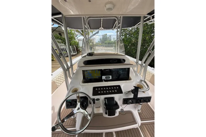 Slide: The Image of 2004 Grady-White Canyon 306 boat helm with steering wheel and navigation controls. - 26