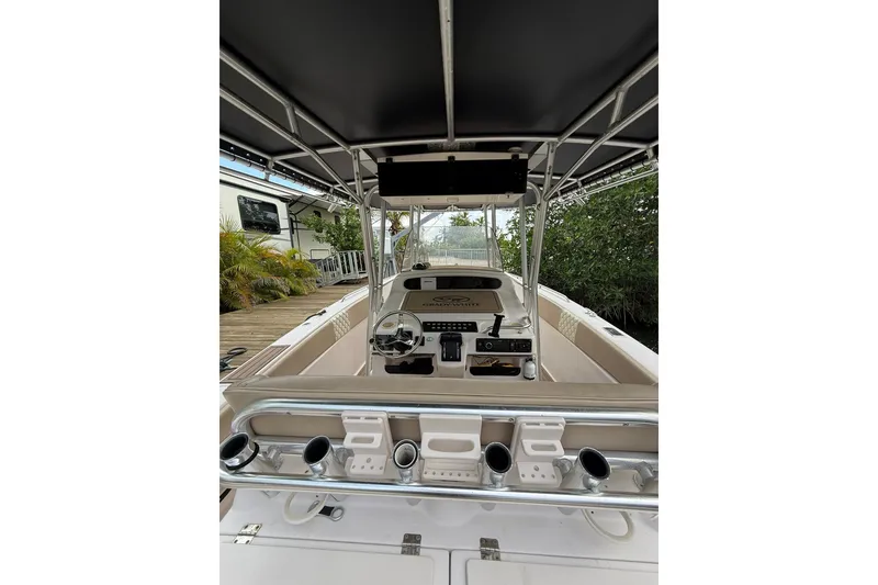Slide: The Image of 2004 Grady-White Canyon 306 boat interior with steering console and rod holders. - 22