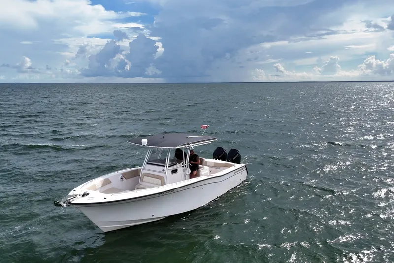 Slide: The Image of 2004 Grady-White Canyon 306 boat on open sea under cloudy sky. - 6
