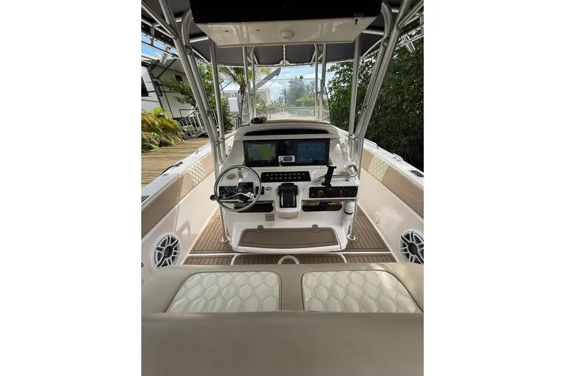 Slide: The Image of 2004 Grady-White Canyon 306 boat cockpit with steering wheel and navigation equipment. - 24