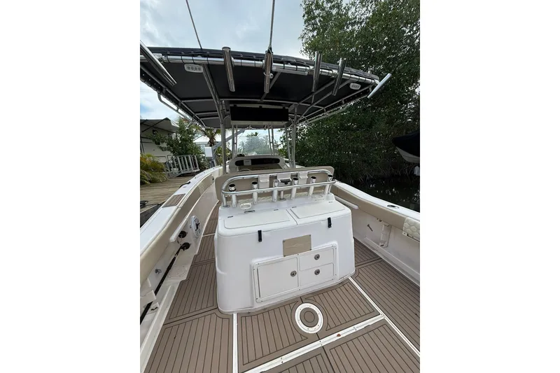 Slide: The Image of 2004 Grady-White Canyon 306 boat interior with T-top and fishing rod holders. - 20