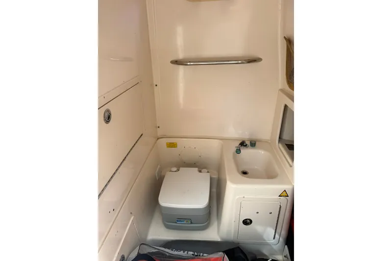 Slide: The Image of 2004 Grady-White Canyon 306 boat interior with compact sink and portable toilet. - 41
