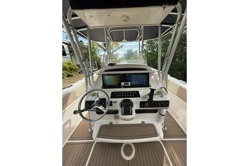Slide: The Image of 2004 Grady-White Canyon 306 boat cockpit with steering wheel and navigation controls. - 25