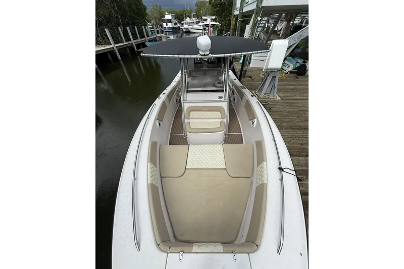 Slide: The Image of 2004 Grady-White Canyon 306 boat docked, featuring spacious seating and sleek design. - 33