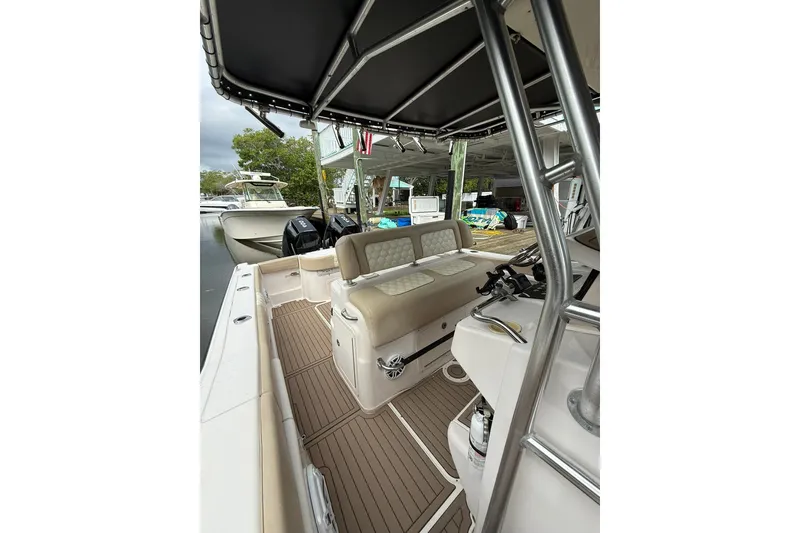 Slide: The Image of 2004 Grady-White Canyon 306 boat interior with seating and helm, docked at marina. - 38