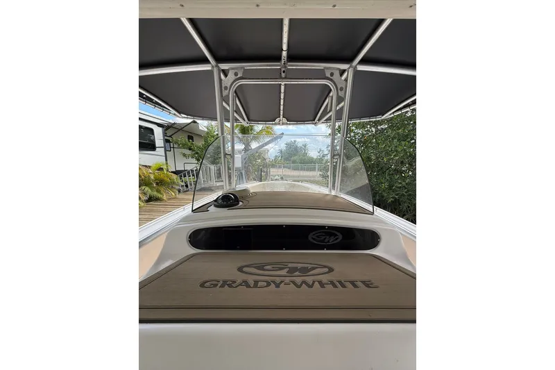 Slide: The Image of 2004 Grady-White Canyon 306 boat interior with canopy and windshield. - 30