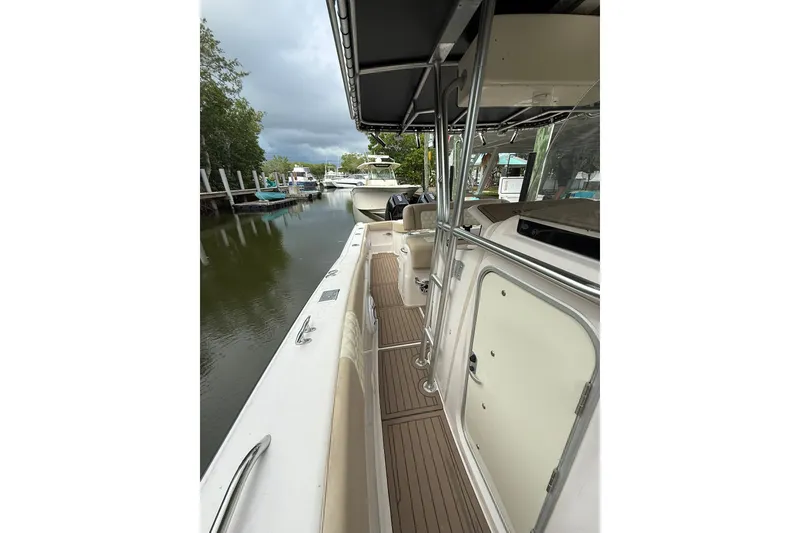 Slide: The Image of 2004 Grady-White Canyon 306 boat docked, featuring sleek design and spacious deck. - 37