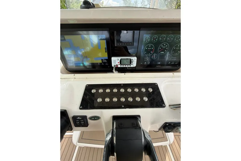 Slide: The Image of Control panel of a 2004 Grady-White Canyon 306 boat with navigation screens. - 29