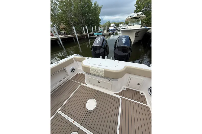 Slide: The Image of 2004 Grady-White Canyon 306 boat with twin outboard engines docked in a marina. - 21