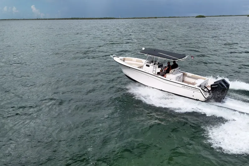 Slide: The Image of 2004 Grady-White Canyon 306 boat cruising on open water. - 1
