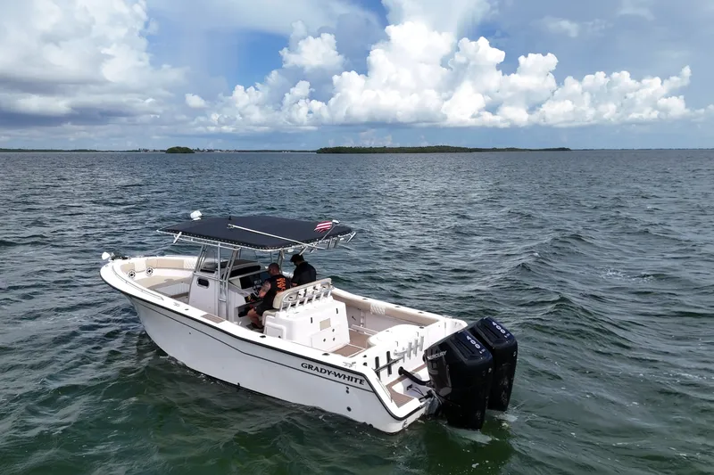Slide: The Image of 2004 Grady-White Canyon 306 boat cruising on open water under a cloudy sky. - 7