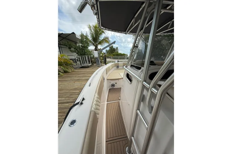 Slide: The Image of 2004 Grady-White Canyon 306 boat docked, showcasing sleek design and spacious deck. - 31