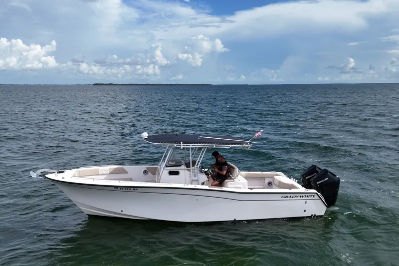 The Image of 2004 Grady-White Canyon 306 boat on open water under a cloudy sky. - 5