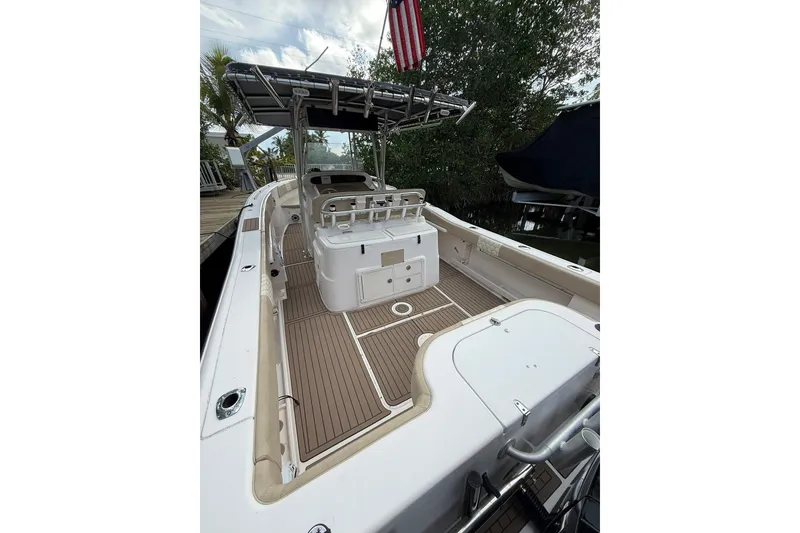 Slide: The Image of 2004 Grady-White Canyon 306 boat with spacious deck and fishing amenities. - 19