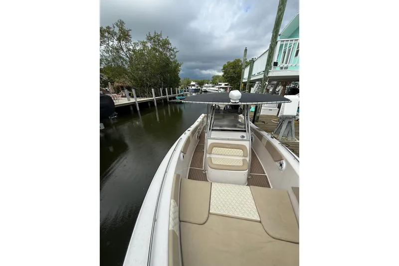 Slide: The Image of 2004 Grady-White Canyon 306 boat docked by a serene waterfront. - 34