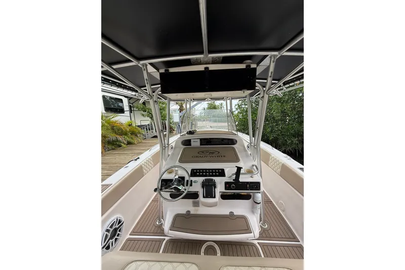 Slide: The Image of 2004 Grady-White Canyon 306 boat interior with steering console and seating. - 23