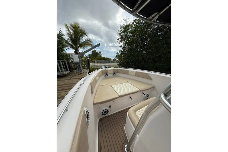 Slide: The Image of 2004 Grady-White Canyon 306 boat interior with cushioned seating and speakers. - 32