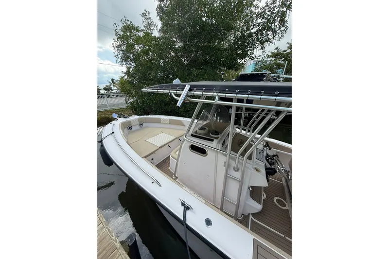 Slide: The Image of 2004 Grady-White Canyon 306 boat docked, featuring spacious deck and sleek design. - 12