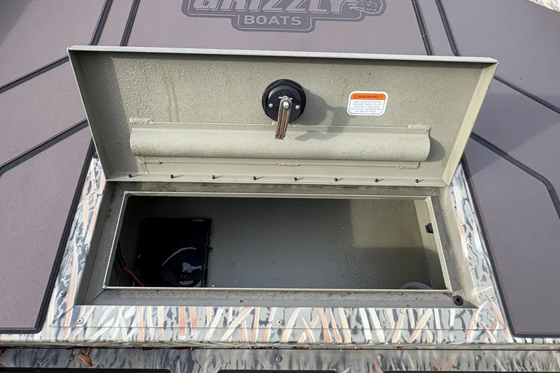 Slide: The Image of Open storage compartment on 2027 Tracker Grizzly 1860 CC boat deck. - 13