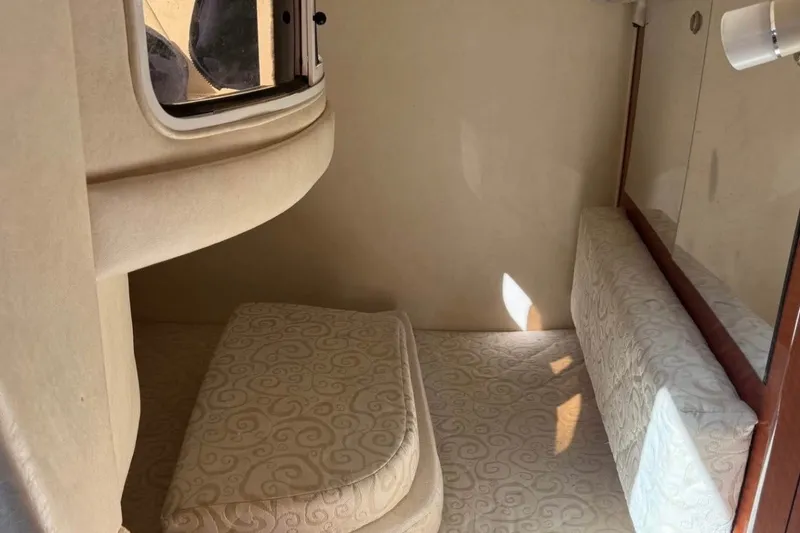 Slide: The Image of Interior cabin of 2005 Sea Ray Sundancer 280 with beige upholstery and window. - 6
