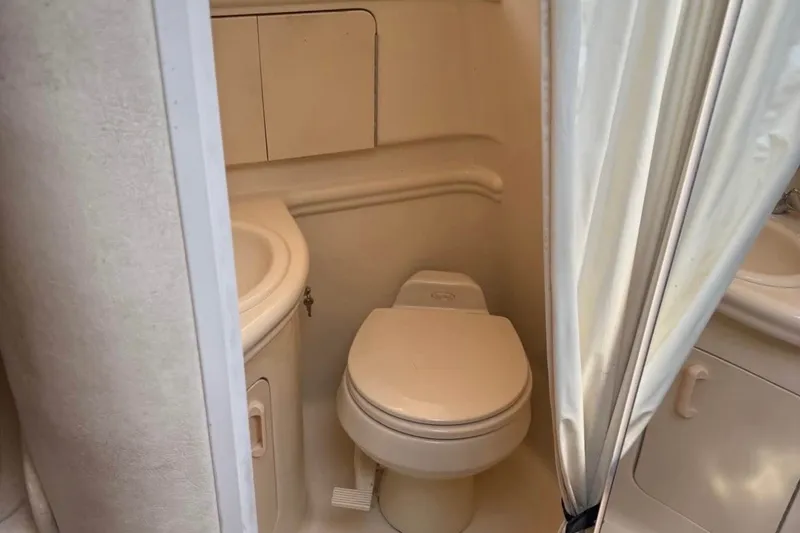Slide: The Image of Compact bathroom in 2005 Sea Ray Sundancer 280 boat, featuring toilet and sink. - 4