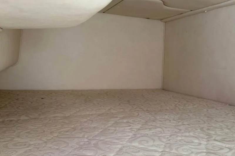 Slide: The Image of Interior cabin of 2005 Sea Ray Sundancer 280 with patterned mattress. - 5
