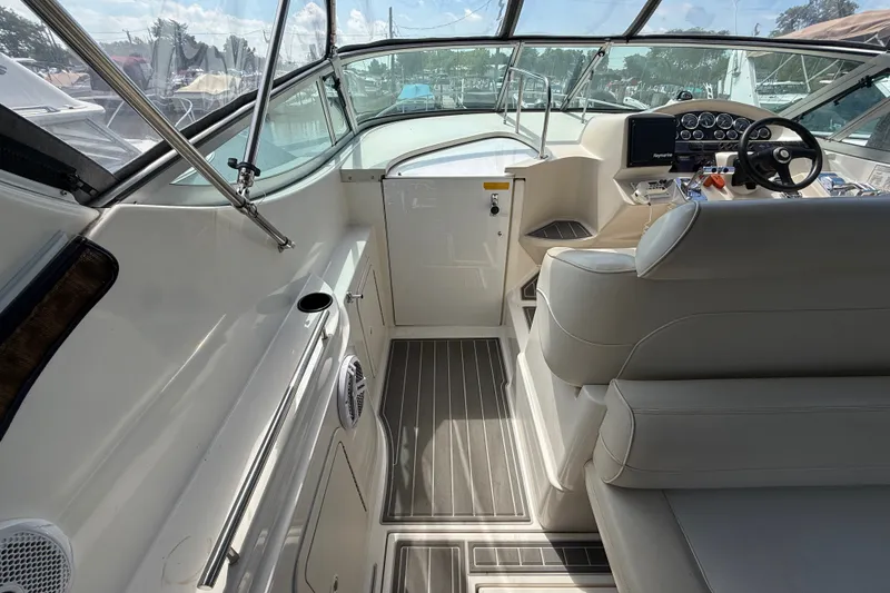 Slide: The Image of 1999 Cruisers Yachts 3075 Rogue interior with helm, seating, and dashboard controls. - 15