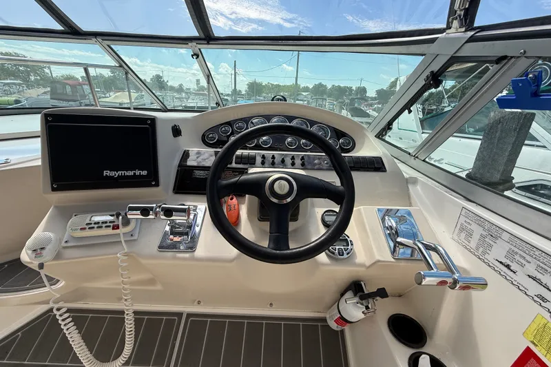 Slide: The Image of 1999 Cruisers Yachts 3075 Rogue helm with Raymarine electronics and steering wheel. - 20